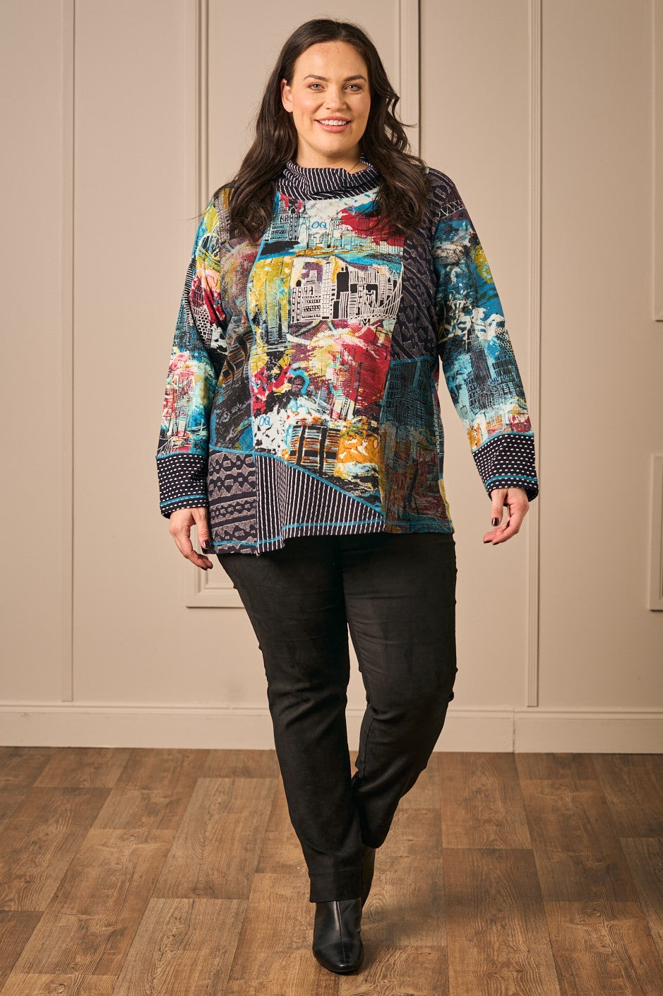 Our model is wearing Orientique patch cowl top in black/blue for Froxx Clothing plus sizes