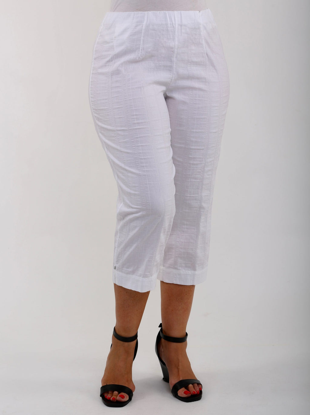 Woman wearing white KJ Brand Wash & Go pedal pushers