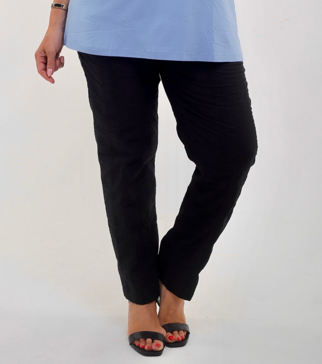 Woman wearing KJ Brand wash & Go stretch trousers in black