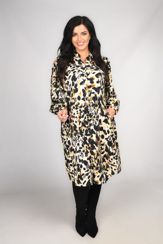 Woman is wearing Masai MaNydema leopard print shirt dress in black and cream for Froxx Clothing plus sizes